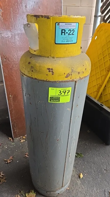 GM Refrigerator Co. R-22 refrigerant cylinder. Features a protective collar handle and dual liquid and vapor valves. Labeled for R-22 chlorodifluorome