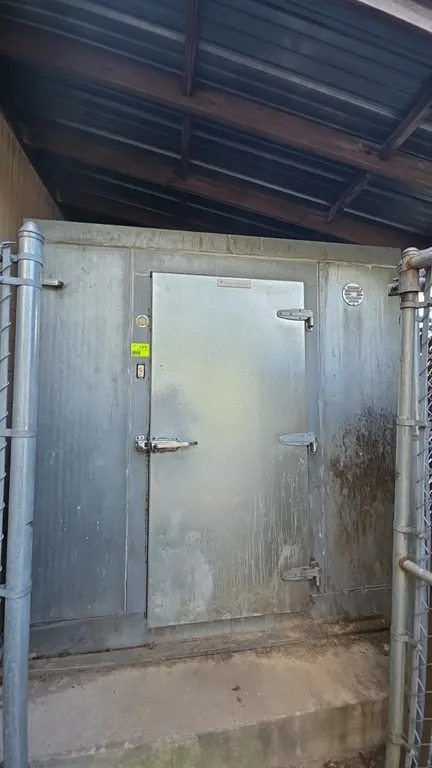 CrownTonka walk-in freezer. Features insulated panels, single hinged door with Kason latch, strip curtains, Russell AE44-140 B 4-fan evaporator, and R