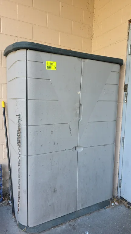 Rubbermaid vertical storage shed with contents. Features heavy-duty resin construction, French double doors, and padlock hasp. Includes assorted inter