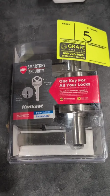 Kwikset Hollis 405HSL keyed entry door lever handle. Features SmartKey security, Microban antimicrobial technology, and a satin nickel finish. Package