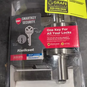 Kwikset Hollis 405HSL keyed entry door lever handle. Features SmartKey security, Microban antimicrobial technology, and a satin nickel finish. Package