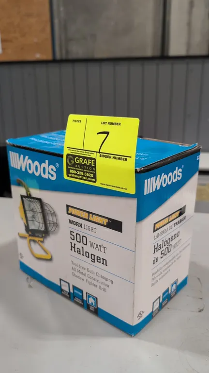 Woods Power Light portable work light. Features 500-watt halogen bulb, metal construction, wire safety grill guard, and top carry handle. Mounted on a