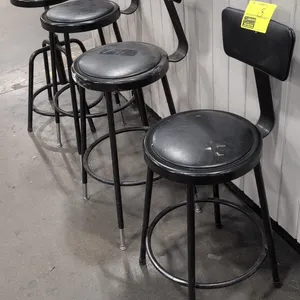 Assorted cushioned bar height stools. Features black faux leather upholstered round seats and backrests, tubular metal frames, and integrated ring foo