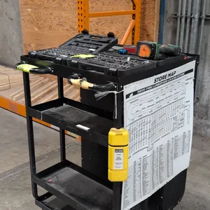 Rolling metal utility cart. Features a lipped top tray, dual push handles, open tiered shelving, and an enclosed 2-door perforated storage cabinet wit