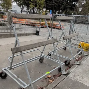 Portable metal flat panel carts. Features carpet-padded horizontal supports, dual bottom resting plates, and rear tubular push handles. 5'L. Mounted o