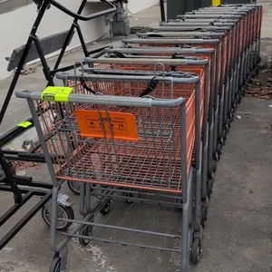 Metal shopping carts. Features orange coated wire baskets, gray tubular metal frames, folding child seats with safety straps, lower wire storage trays