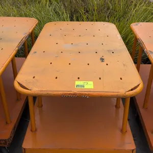 Metal 2-tier platform cart. Features orange finish, slotted upper deck, tubular upright supports, and integrated push handles. 60"L x 30"W. Mounted on