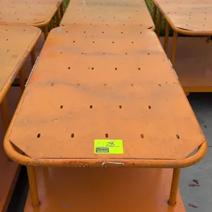 Metal 2-tier platform carts. Features orange steel construction, tubular frame uprights, and integrated perimeter push handles. 60" x 30". Mounted on 