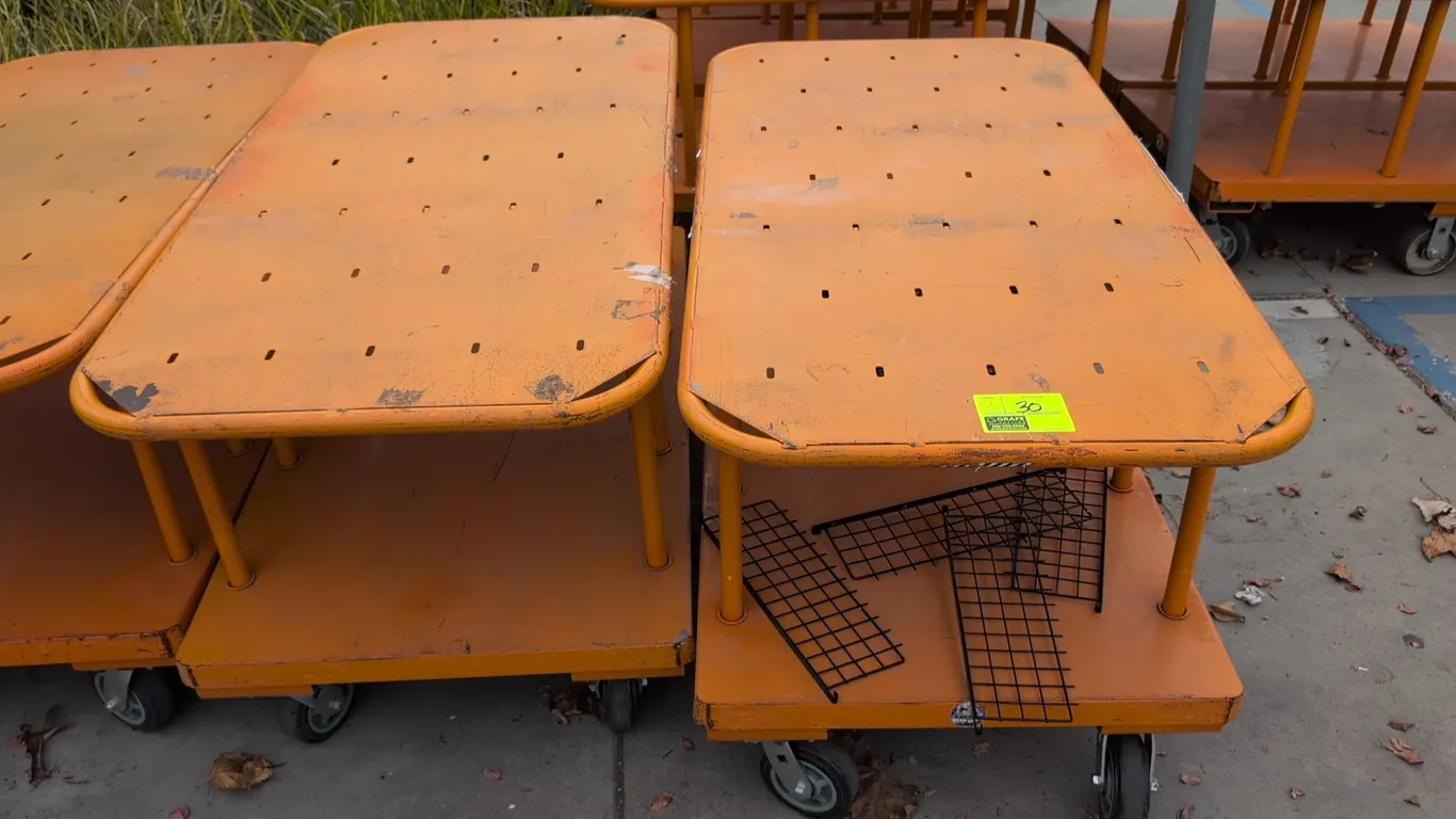 Metal 2-tier platform carts. Features orange finish, slotted upper deck, and lower platform shelf. 60" x 30". Mounted on casters. Contents not include