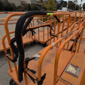 Metal platform lumber carts. Features tubular divider uprights, solid metal platform deck, and orange finish. Dimensions: 54" x 30". Mounted on caster