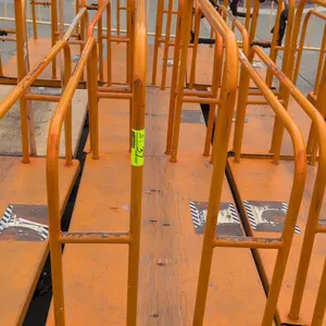 Metal platform lumber carts. Features tubular steel upright dividers and solid platform deck on a steel frame with an orange finish. Mounted on caster