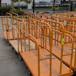 Metal platform lumber carts. Tubular steel divider rails with wood deck on steel frame. Dimensions: 54" x 30". Mounted on casters.