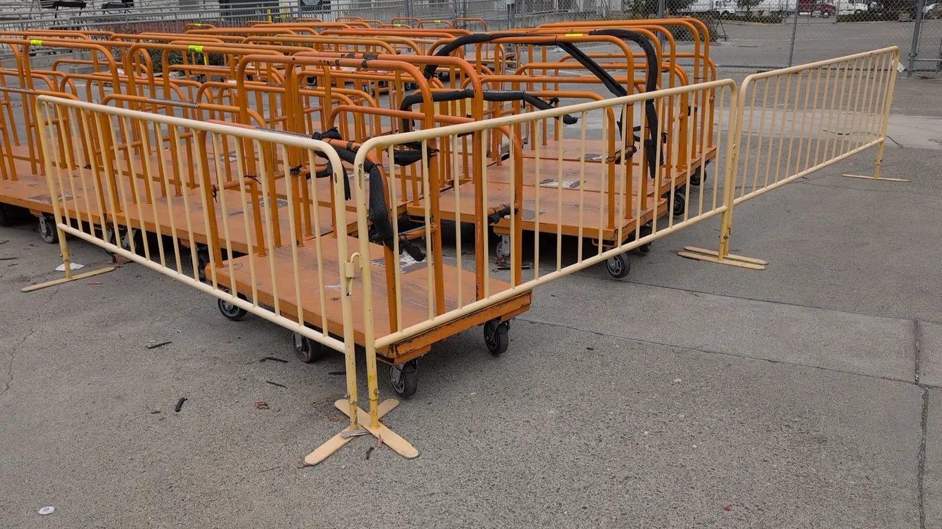 Metal crowd control stanchions. Features tubular metal construction, vertical pickets, interlocking connector hooks, and flat support feet. 101"L each