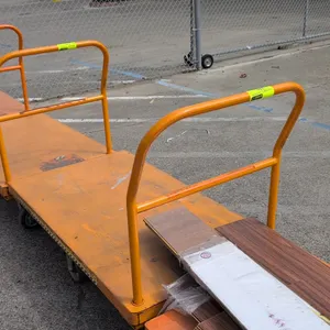 Metal platform cart. Features orange painted steel construction, removable tubular push handle, and a 6-wheel tilt configuration with rigid center whe