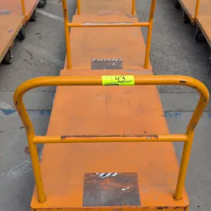 Metal platform carts. Features orange painted steel construction, removable tubular steel push handle, and a 6-wheel caster configuration with center-