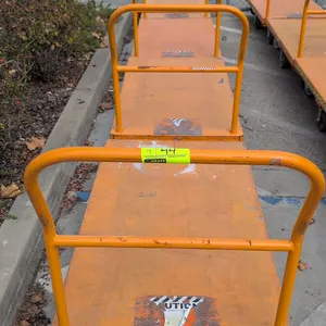 Metal platform carts. Features orange steel platform deck, tubular push handle, and 6-wheel configuration with center wheels and swivel casters. 54"L 