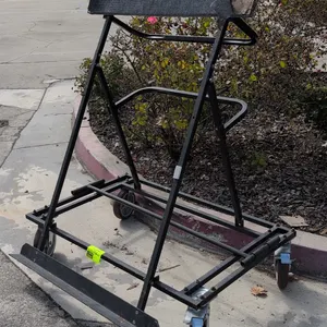 4'L metal portable flat panel cart. Features carpet-padded upper support rail, bottom support ledge, and dual tubular handles. Mounted on swivel caste