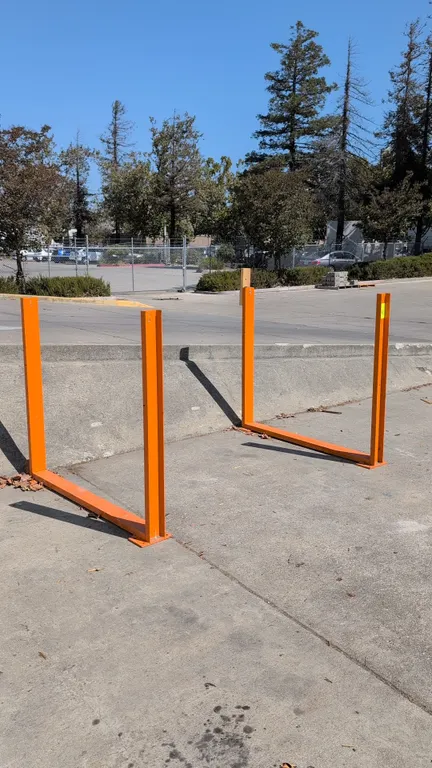 Metal stands. Features orange painted steel construction and pre-drilled base plates for floor mounting. 56" x 48"H.