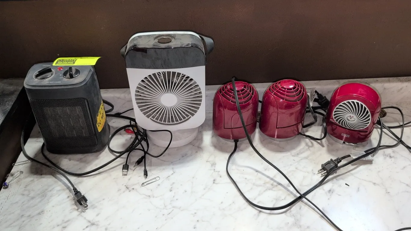 Assorted desk fans and space heater. Includes (3) Vornado Flippi V6 compact personal air circulator fans, (1) Mainstays WSH10C2ABB ceramic fan-forced