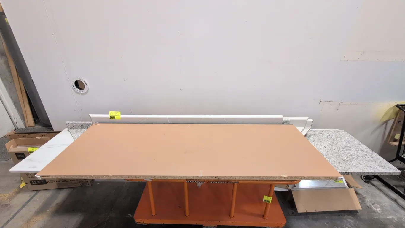 Assorted laminate countertops. Features multiple pieces in various faux marble and granite patterns, with select sections including integrated backspl