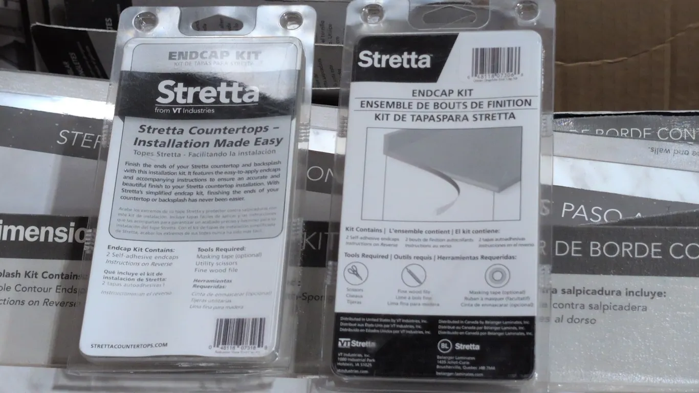 Assorted countertop installation supplies. Includes VT Dimensions reversible contoured endsplash kit in Carrara Bianco finish, Stretta self-adhesive e