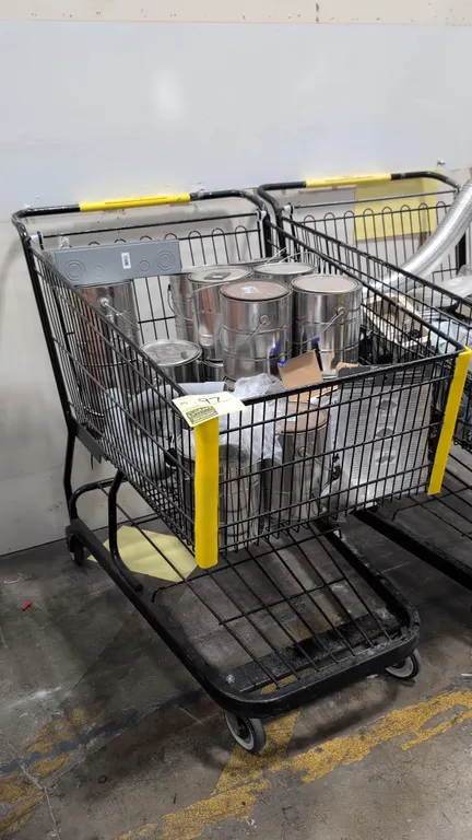 Assorted metal paint cans and building supplies with shopping cart. Includes 1-gallon metal paint cans, electrical enclosure box, Carlon PVC conduit e