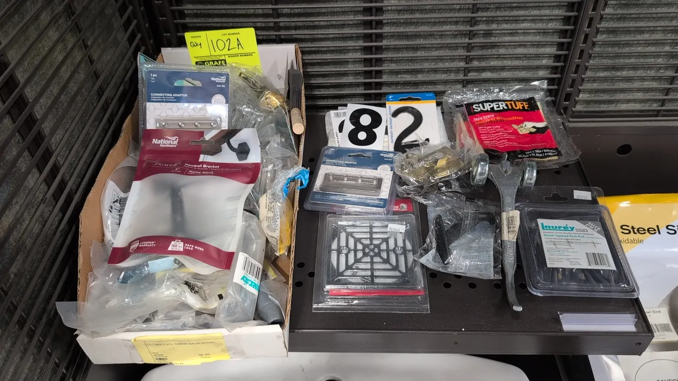 Assorted building supplies and hardware. Includes National Hardware barn door connecting adaptors, handrail bracket, Lauréy cabinet pulls, Thrifco plu