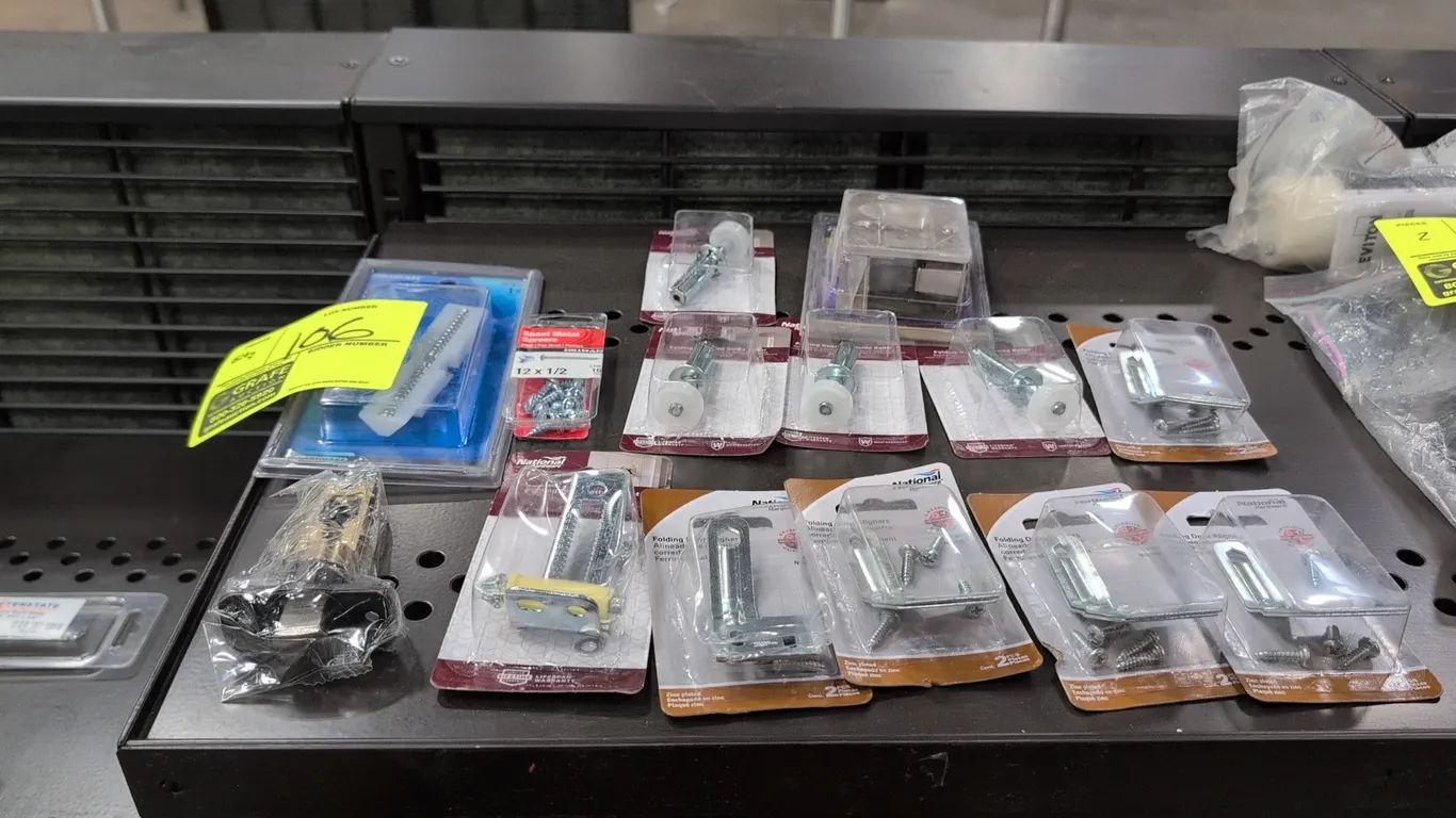 Assorted door hardware and fasteners. Includes National Hardware folding door top guide rollers, folding door aligners, bi-fold door hardware, Hillman