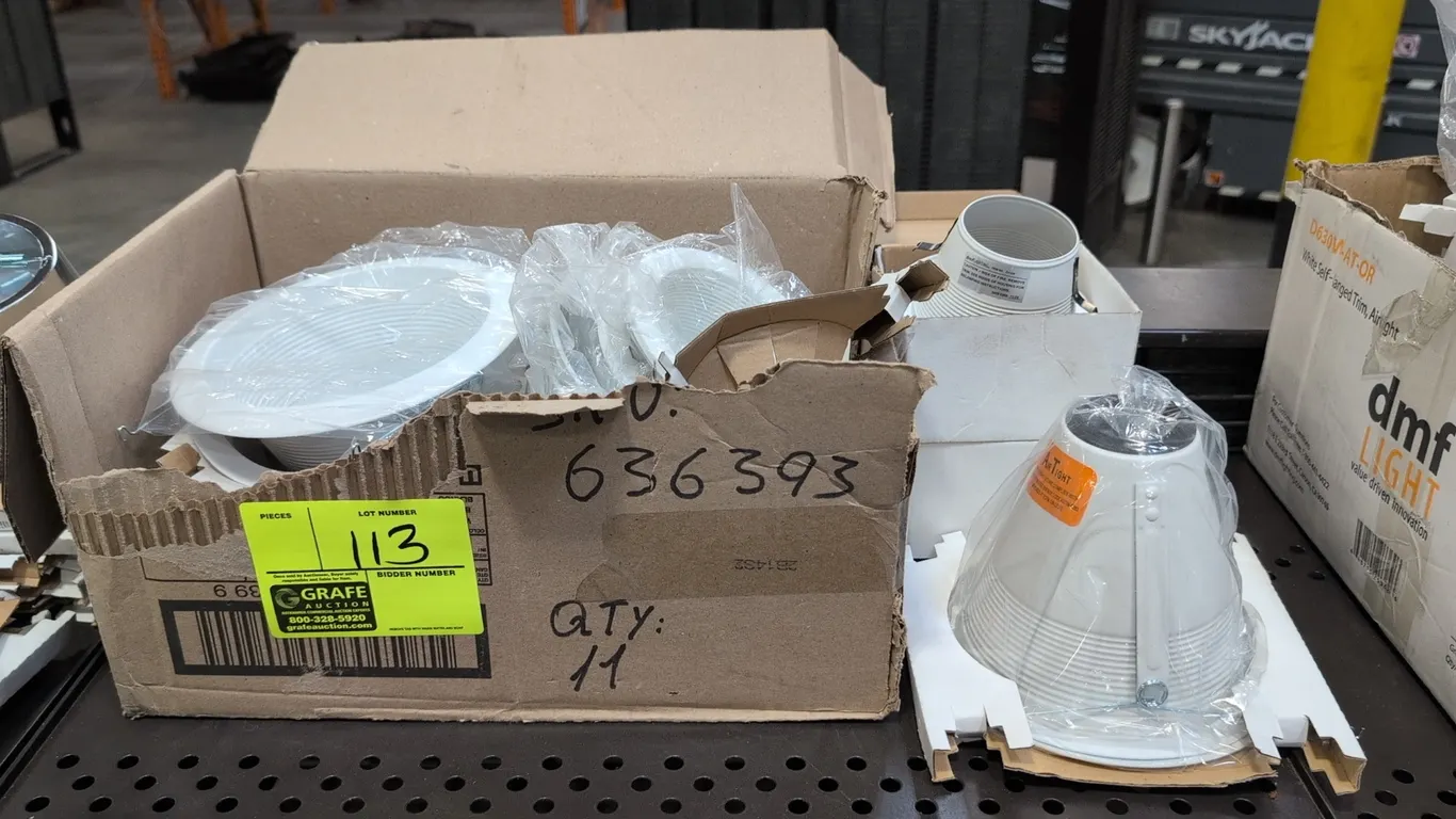 Assorted DMF Lighting recessed light fixture trims. Features 3" to 6" sizes with white stepped baffle design and metal construction. Includes model D4