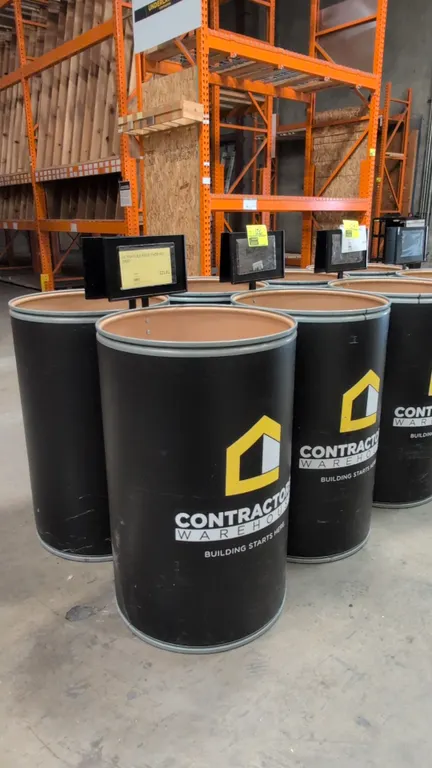 Fiber barrels with metal rims and sign stands. Features fiberboard construction, metal chimes, mounted black metal sign holders, and Contractors' Ware