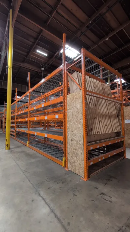 112'L of HMH metal teardrop pallet racking. Includes (8) 12'L sections and (2) 8'L sections. Features 5-1/2" crossbars, wire mesh decking, and wood de