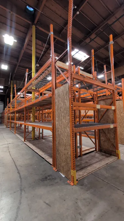 (8) 12' and (2) 8' sections of HMH metal teardrop pallet racking. Features 5-1/2" crossbars, wood and wire decking. Uprights measure 42"W x 192"H.