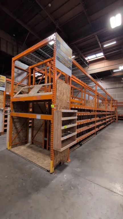 HMH metal teardrop pallet racking. Includes (8) 12' sections and (2) 7-1/2' sections with 5-1/2" crossbars, wood and wire decks, and wooden bin divide