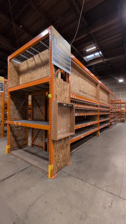HMH metal teardrop pallet racking. Includes (8) 12' sections and (2) 7½' sections. Features 4" to 5½" crossbars, wood and wire decking, and wood bin d