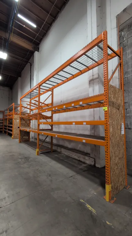 12' of HMH metal teardrop pallet racking. Features 4" to 5-1/2" crossbars, wood decking, and wire mesh decking. 34"W x 144"H. Note: Merchandise bars n