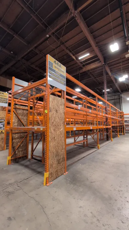 (8) 12' and (2) 7.5' sections of HMH metal teardrop pallet racking. Features 4" to 5.5" crossbars, wood decking, and wire decking. Uprights measure 34