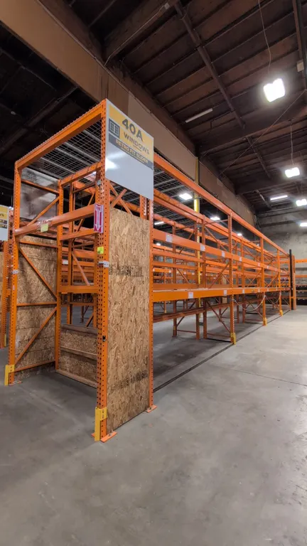 HMH metal teardrop pallet racking. Includes (8) 12' and (2) 7½' sections. Features 4" to 5½" crossbars with locking pins, wire decking, and wood decki