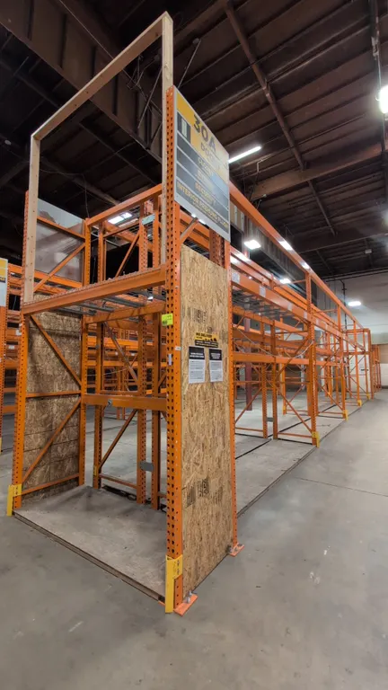 HMH metal teardrop pallet racking. Includes (8) 12' and (2) 7-1/2' sections. Features 5" to 6" crossbars, wood decking, and wire decking. Upright dime