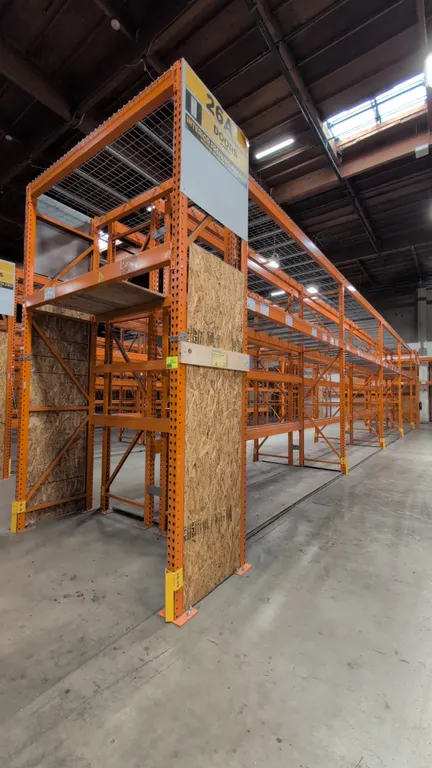 (8) 12' and (2) 7-1/2' sections of HMH metal teardrop pallet racking. Features 4" to 6" crossbars with wire decking and wood decks. Upright dimensions