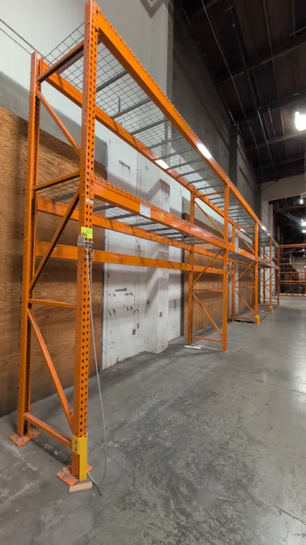 12' sections of HMH metal teardrop pallet racking. Features 4" to 6" crossbars and wire decks. Dimensions: 34"W x 144"H.