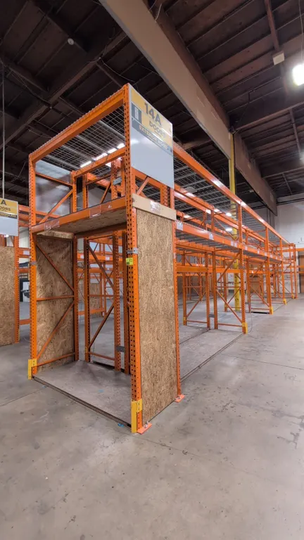 (8) 12' and (2) 7½' sections of HMH metal teardrop pallet racking. Features 4" to 6" crossbars, wire mesh decking, and wood decking. Upright dimension