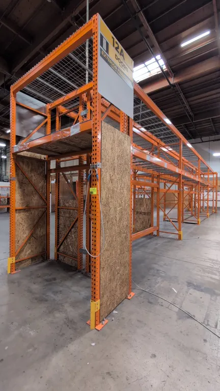 HMH teardrop pallet racking. Includes (8) 12' sections and (2) 7-1/2' sections. Features 4" to 6" crossbars, wood decking, and wire decking. Uprights