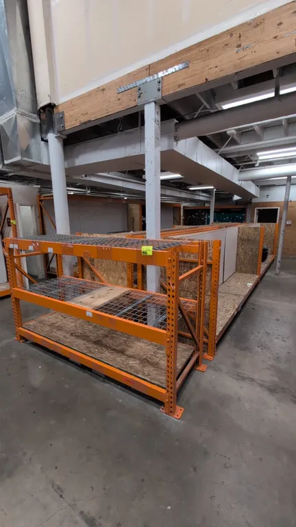 56'L of HMH metal teardrop pallet racking across (4) 12' sections and (1) 8' section. Features 4" to 5" crossbars, wood and wire decks, and pegboard b
