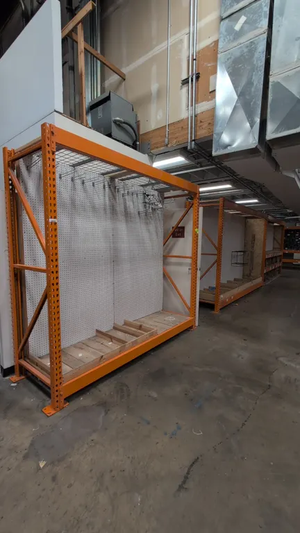 (1) 8' and (2) 12' sections of HMH metal teardrop pallet racking. Features 4" to 6" crossbars, wood and wire decking, and pegboard backing. Upright di