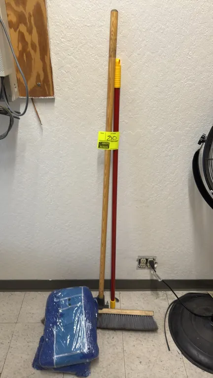 Push broom with dry mop heads. Includes a push broom with wooden handle, an additional red mop handle, and packaged blue dry mop replacement heads.