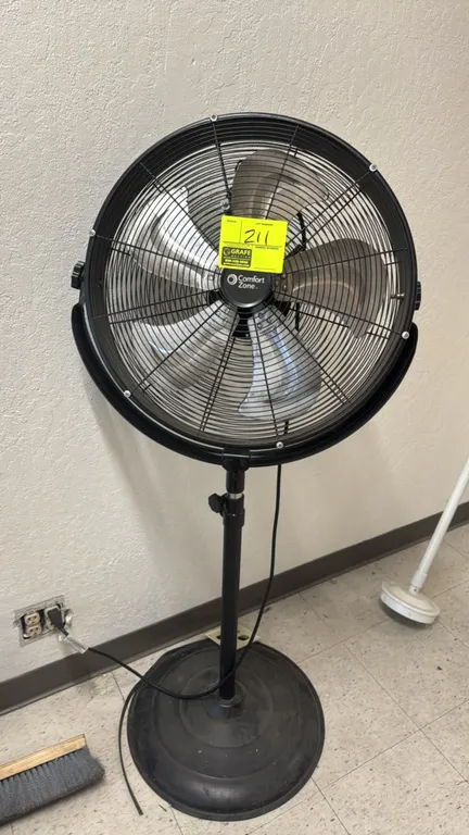 Comfort Zone 20" pedestal fan. Features tilt-adjustable head, metal blades, wire safety guard, and adjustable height. Mounted on a round pedestal base