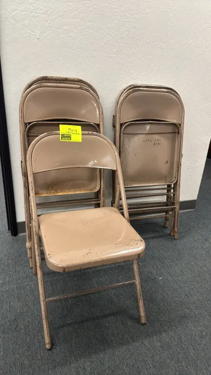 Metal folding chairs. Features tubular metal frame construction, contoured backrest, and folding mechanism. Tan painted finish.