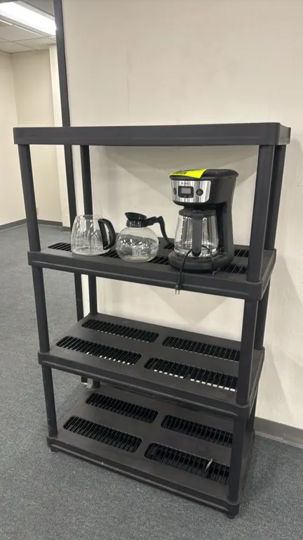 Poly 4-tier shelving rack. Features molded black plastic construction and ventilated shelves. Dimensions: 36"W x 18"D x 55"H. Contents not included.