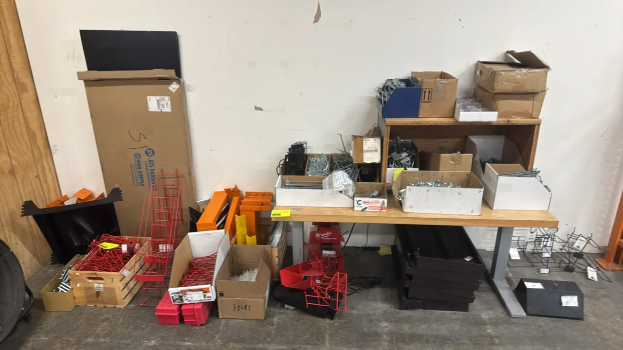 Package lot of assorted merchandising and shelving accessories. Includes pegboard and slatwall hooks, wire display racks and holders, shelf brackets,