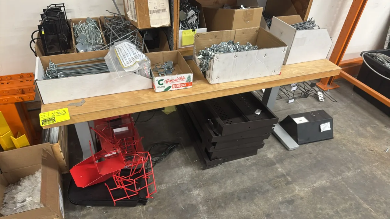 Wood top table with metal frame. Features a wood top surface, under-mount wiring, and gray metal T-base legs. 60" x 30". Contents not included.